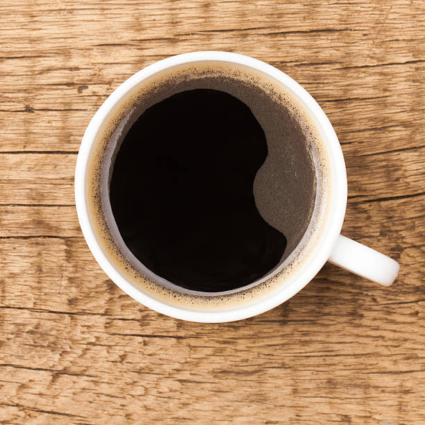 istock Coffee cup on wooden table - view from top 535470527