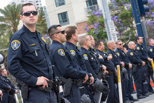 San Diego, California, USA - May 27, 2016: San Diego police officers stand on watch in an effort to keep the peace at an anti-Trump demonstration outside a Trump rally at the San Diego Convention Center.