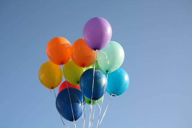 istock Colorful balloons in a clear blue sky 535474684