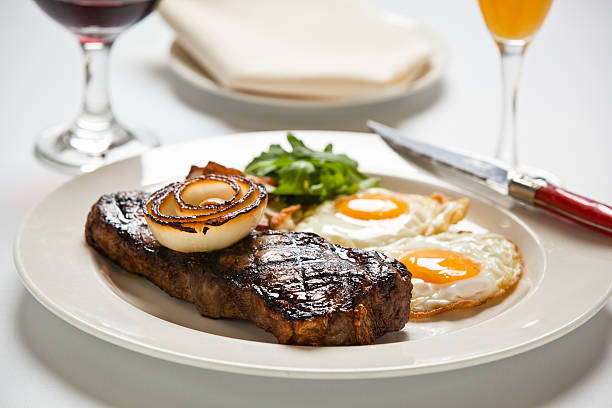 Steak and Eggs Steak and eggs on white table cloth steak and eggs breakfast stock pictures, royalty-free photos & images
