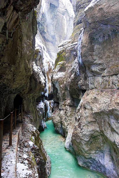 Amazing Partnachklamm in Garmisch-Partenkirchen, Germany Shot of the amazing Partnachklamm in Garmisch-Partenkirchen, Germany, on a winter day. The Partnach Gorge is very popular in summer as well as in winter. Especially in winter, you can see many icicles and the turquoise color of the Partnach river. partnach gorge stock pictures, royalty-free photos & images