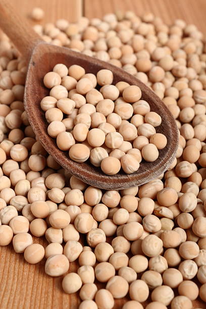 istock Whole yellow peas in wooden spoon 535477034