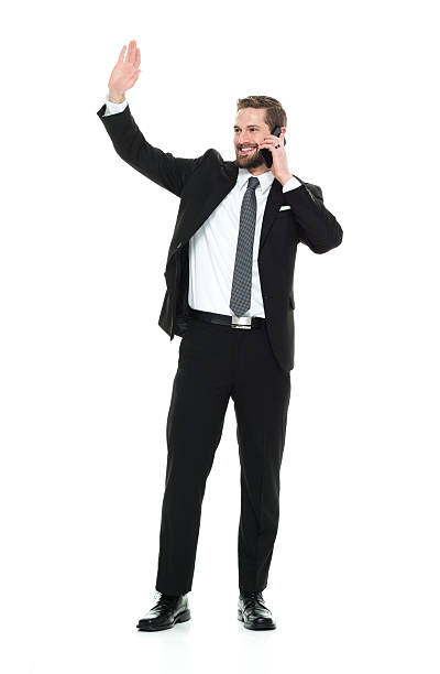 istock Smiling businessman on phone and waving hand 535477844