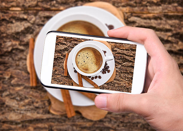 istock Hands taking photo coffee cup with smartphone. 535478895
