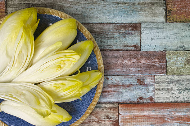 A pair of Belgian endive (also called chicory). Endive is often used to make hors d'oeuvres or salad. Isolated on white.