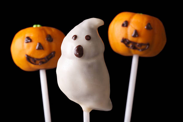 istock Halloween cake pop spooky and pumpkins isolated on a black 535480358