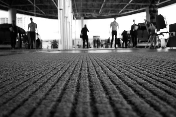 Perspective of doormat Perspective of doormat with background is blur of people. (selective focus, back and white image) mat stock pictures, royalty-free photos & images