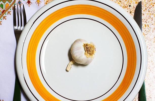 istock Whole Garlic Bulb on Vintage Dinner Plate with Silverware 535483012