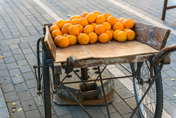 istock Fresh oranges on vintage wooden cart 535483490