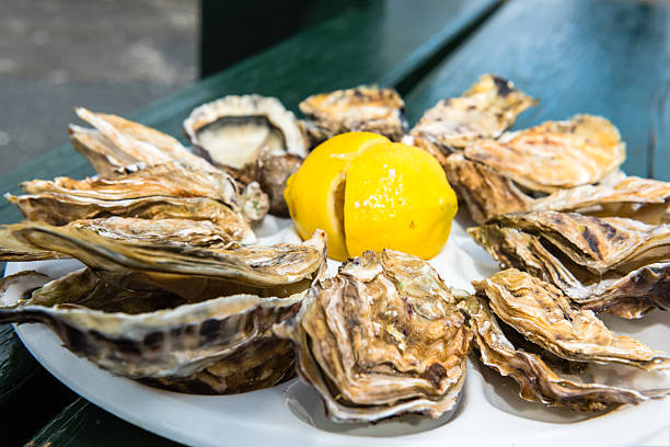 Dozen oysters on a plastic plate stock photo