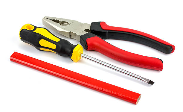 istock screwdriver pliers and a pencil on a white background 535485134