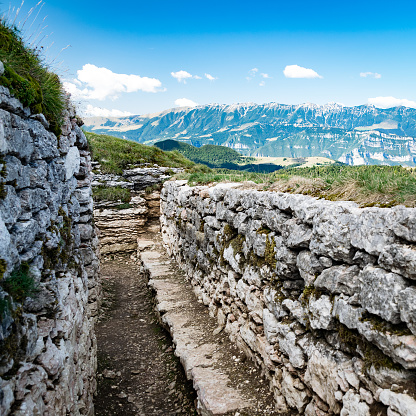 Trench dug in the rock dating back to World War I located on the Italian alps.
