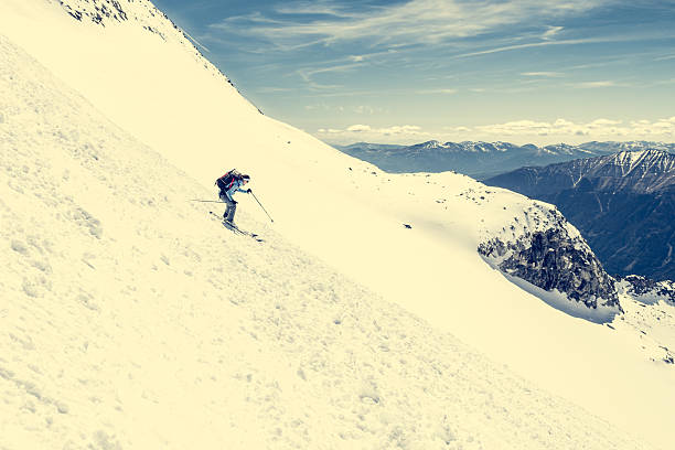 istock Female skier tackling a steep slope. 535485732