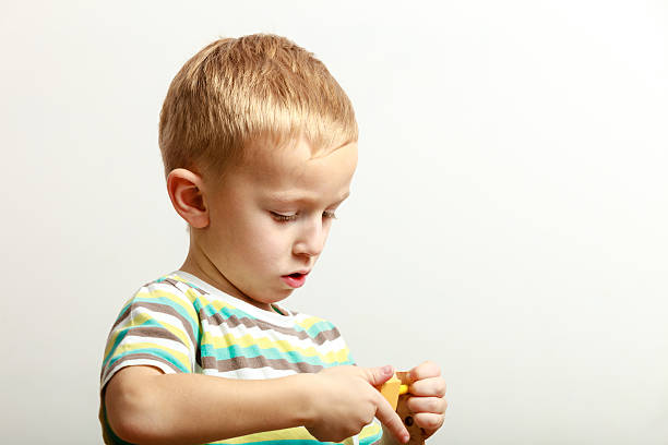 istock Little boy child playing with building blocks toys interior. 535485962
