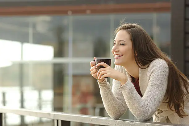 Photo of Happy woman thinking at breakfast on vacation