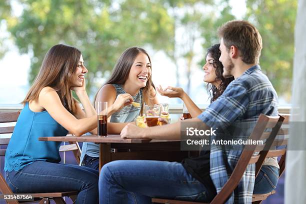 Group Of Friends Talking And Drinking At Home Stock Photo - Download Image Now - Friendship, Restaurant, Family