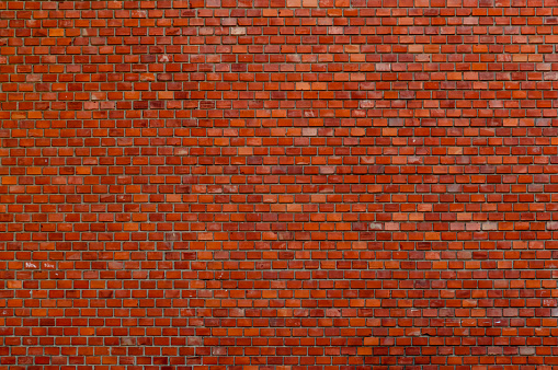 Textured old red brick wall background with copy space