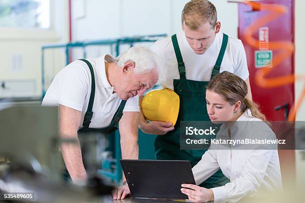 Manager Talking With Plant Workers Stock Photo - Download Image Now - 2015, Active Seniors, Adult