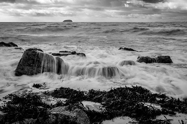 istock seascape at high tide, waves crashing over rocks on beach 535490363