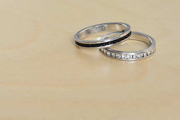 istock Wedding rings on wooden background. 535493417