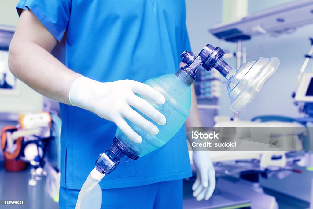 Doctor holds breathing bag with face mask. Anesthetic Stock Photo