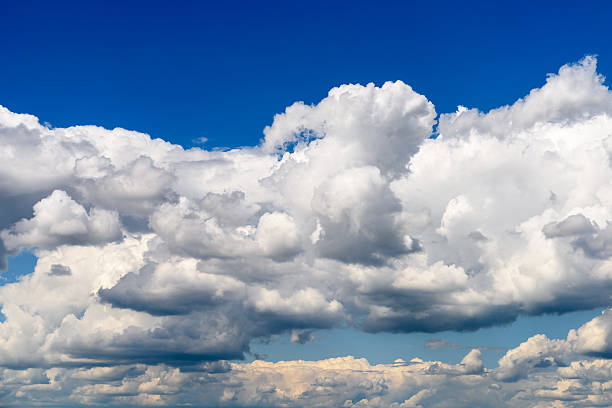 istock White Cumulus Clouds And Grey Storm Clouds On Blue Sky 535495784