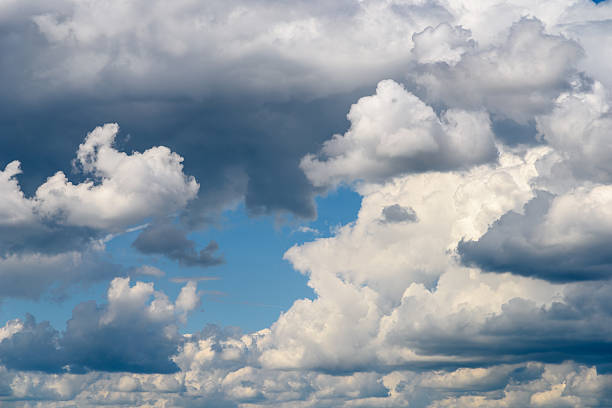 istock White Cumulus Clouds And Grey Storm Clouds On Blue Sky 535495894