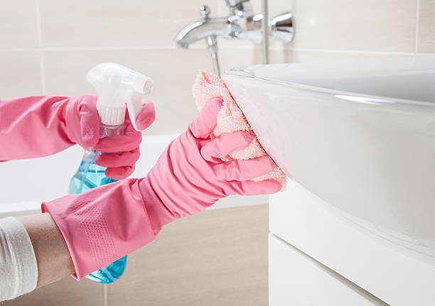 Housemaid cleaning a bathroom, closeup shot