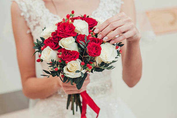 istock Red wedding bouquet in hands of bride closeup 535501042