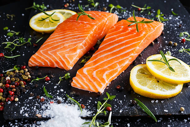 istock fresh raw salmon fillet with aromatic herbs, spices. 535501118