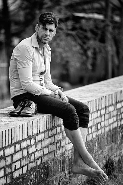 istock Man sits on a countryside wall outdoors 535501436