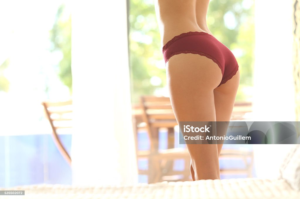 Perfect woman butt wearing lingerie Perfect woman butt wearing lingerie in the bedroom at home Buttocks Stock Photo