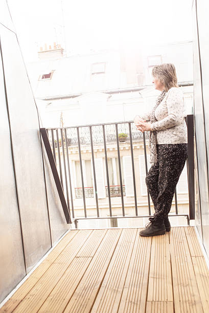 istock Senior woman happy on Paris balcony 535503416