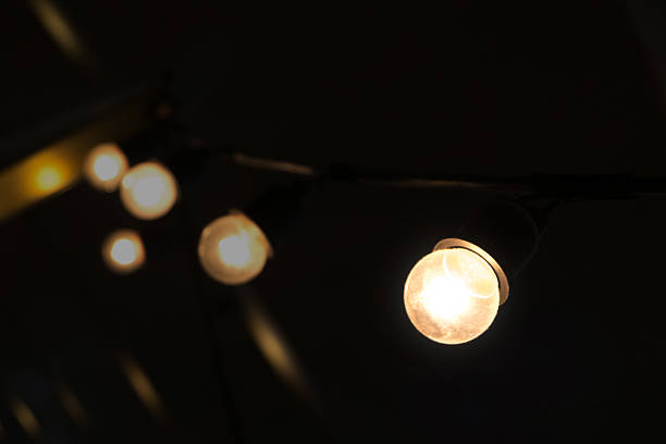 istock decorating hanging bulbs light in  dark place. 535504404
