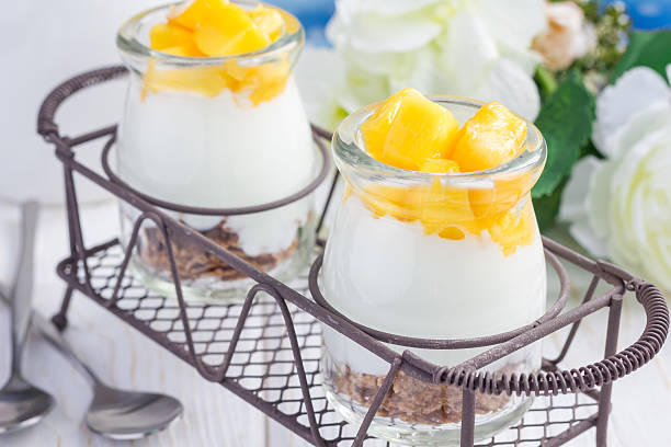 istock Breakfast dessert with bran flakes, plain yogurt and mango, closeup 535505778