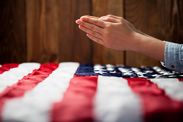istock Hands praying over american flag 535506358
