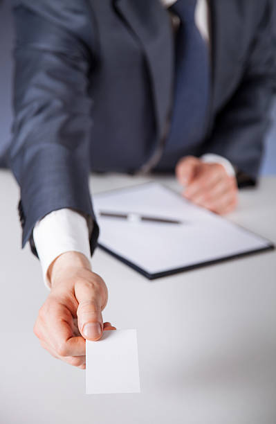 istock Man's hand reaching out a business card 535507356