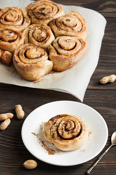 istock Fresh muffins with cinnamon and nuts on a wooden 535509346