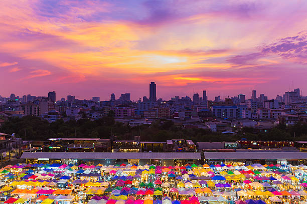 istock Dramatic sky background over night market rooftop and city downtown 535512592