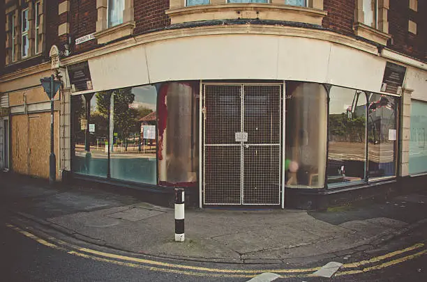 The front of a closed shop at a street corner in the outskirts of Bristol city, England, United Kingdom.