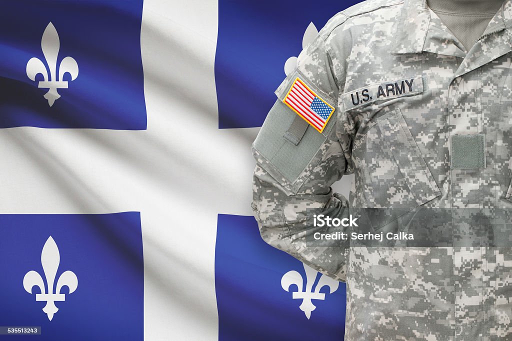 American soldier with Canadian province flag on background - Quebec 2015 Stock Photo