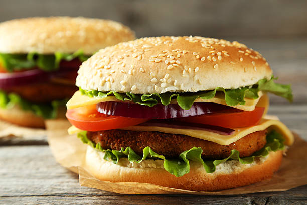 istock Fresh burgers on grey wooden background 535514071