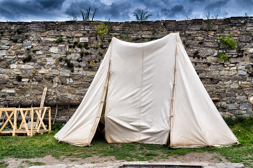 White tent on the ancient walls and the background of the sky
