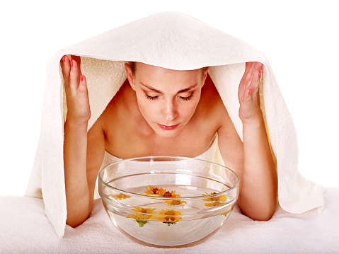 Facial massage with steam treatment.Towel on head
