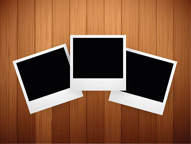 Vector illustration of Polaroids over wooden background