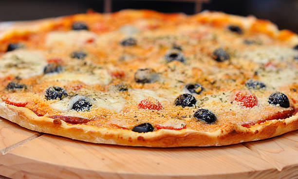 istock Pizza with ham, pepper, tomato and olives 535516329