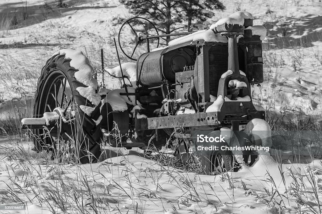 Old Workhorse Early 1900s era tractor in a snow covered field 2015 Stock Photo