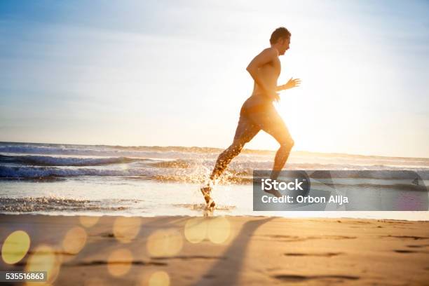 Man Running On The Beach Stock Photo - Download Image Now - Footprint, Men, Running