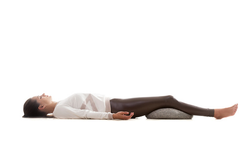 Successful European gorgeous woman in white shirt, black pants laying on sofa opening her diary. Pic from top of pretty businesswoman preparing for a day. Italian student relaxing at home. Business