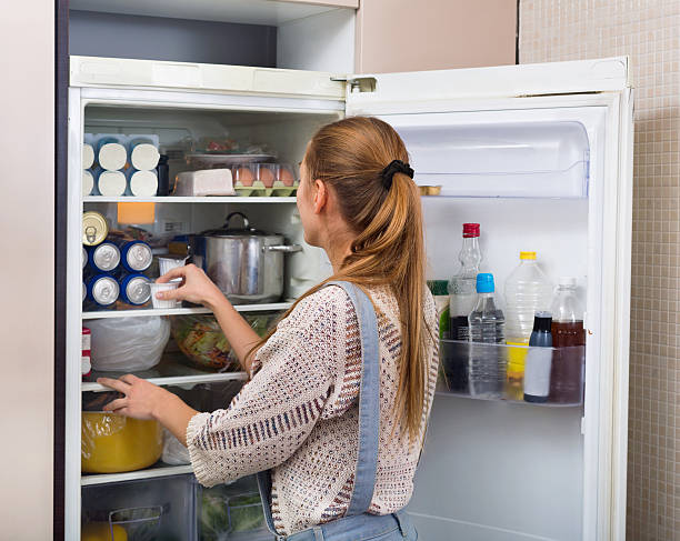 istock Accurate and smiling  girl standing near fridge 535518402